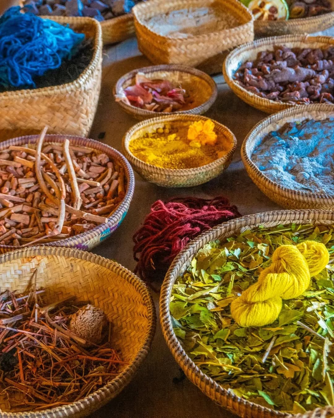 Baskets of plant materials and coloured yarn used for natural dyeing