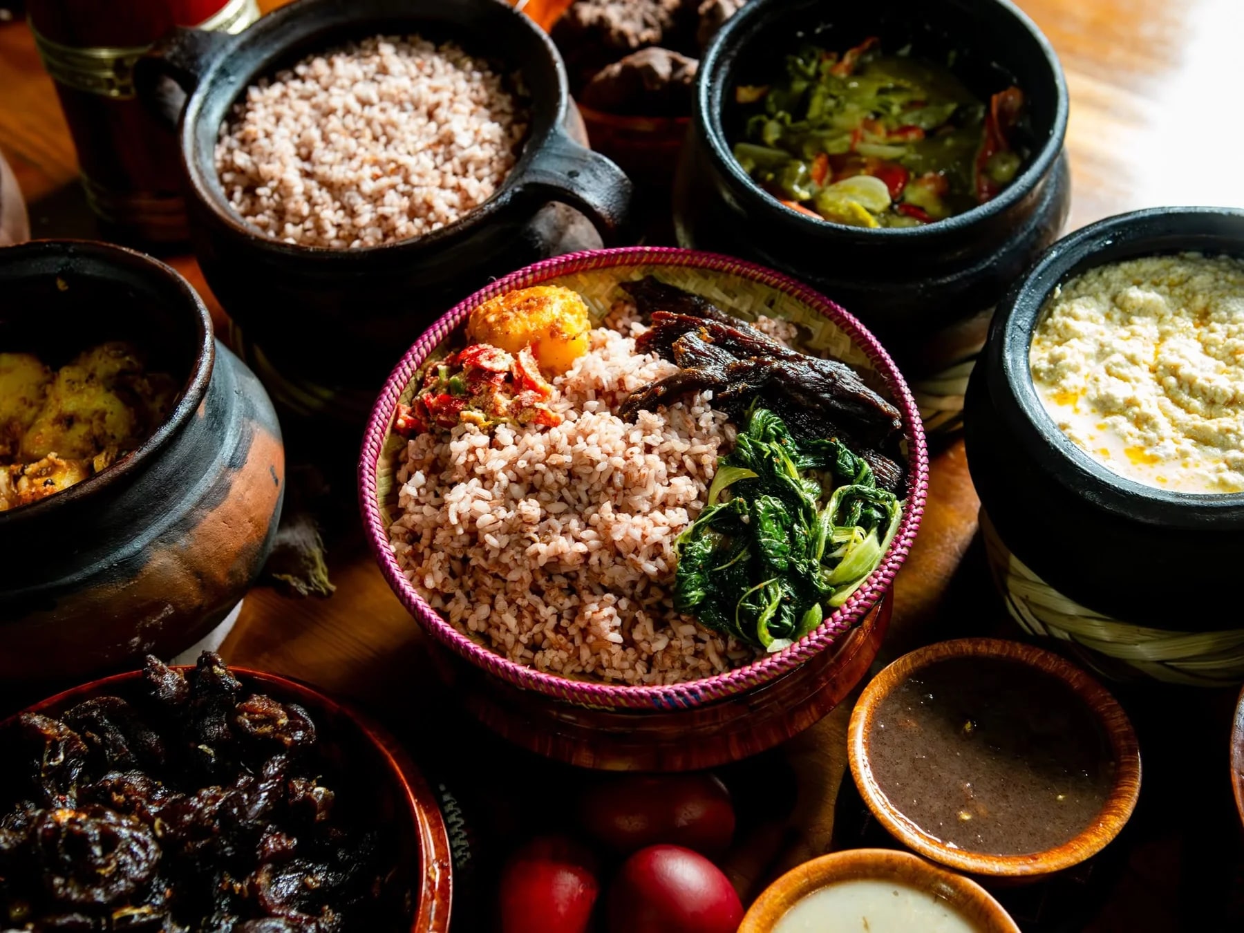 Bowls of traditional Bhutanese dishes arranged on a wooden table